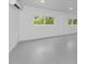 Clean, bright living space with gray floors, white walls and natural light at 920 Lena Ln, Sarasota, FL 34240
