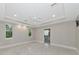 Spacious main bedroom featuring a tray ceiling, recessed lighting, and tiled floors at 920 Lena Ln, Sarasota, FL 34240