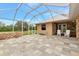 A screened in patio includes brick accents, stone floors and white Adirondack chairs at 920 Lena Ln, Sarasota, FL 34240