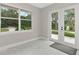 Bright, airy sun room with large windows and doors leading to the backyard, offering serene views at 920 Lena Ln, Sarasota, FL 34240