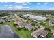 Captivating aerial of a residential area with a large lake, green spaces, and homes with manicured lawns at 9927 58Th E St, Parrish, FL 34219