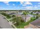 A lovely aerial view of a home by a lake in a neighborhood surrounded by green foliage at 9927 58Th E St, Parrish, FL 34219