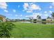 A sprawling backyard with lush green grass and serene water views offers ample space for recreation at 9927 58Th E St, Parrish, FL 34219