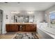 Luxurious bathroom with a soaking tub, dual vanity, and ample cabinet space at 9927 58Th E St, Parrish, FL 34219