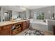 Bright bathroom featuring a soaking tub, large window, and spacious vanity area at 9927 58Th E St, Parrish, FL 34219