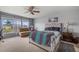 Inviting bedroom with a ceiling fan and a cozy seating area near the bright window at 9927 58Th E St, Parrish, FL 34219