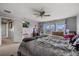 Spacious bedroom with large windows, ceiling fan, and television for comfortable living at 9927 58Th E St, Parrish, FL 34219