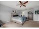 Comfortable bedroom featuring a ceiling fan, dresser, and plush carpeting for a relaxing atmosphere at 9927 58Th E St, Parrish, FL 34219