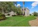 A beautifully landscaped yard complements this home, which features mature trees and a well-maintained lawn at 9927 58Th E St, Parrish, FL 34219