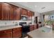 Close up view of kitchen featuring dark cabinets, stainless steel microwave and a window overlooking the backyard at 9927 58Th E St, Parrish, FL 34219