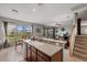 Open kitchen view showcasing sink, countertops, and a glimpse of the adjacent living area and stairs at 9927 58Th E St, Parrish, FL 34219