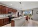 Well-lit kitchen with dark cabinetry, modern appliances, and views of the outdoor scenery at 9927 58Th E St, Parrish, FL 34219