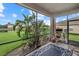 An enclosed lanai space with verdant landscaping offers peaceful relaxation and picturesque outdoor views at 9927 58Th E St, Parrish, FL 34219