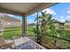 A relaxing lanai offers tranquil water views, lush tropical landscaping, and serene shaded lounging at 9927 58Th E St, Parrish, FL 34219