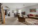 Cozy living space with comfortable seating arrangements, dining area, and staircase at 9927 58Th E St, Parrish, FL 34219