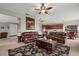 Open-concept living room with leather sofas, a decorative rug, and seamless flow into the kitchen and dining areas at 9927 58Th E St, Parrish, FL 34219
