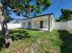 A cozy backyard with healthy grass, a white privacy fence, and a covered patio space at 1019 34Th W Ave, Bradenton, FL 34205