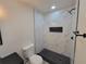 The bathroom's tiled shower has a black shower head and sleek black hardware accents at 1019 34Th W Ave, Bradenton, FL 34205
