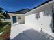 Side view showcasing the entrance, painted white, and a bright blue door at 1019 34Th W Ave, Bradenton, FL 34205