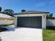Close-up of the garage door, showing the house number and exterior lighting at 1019 34Th W Ave, Bradenton, FL 34205