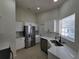 Well-lit kitchen featuring stainless steel appliances, white cabinets, and quartz countertops at 1019 34Th W Ave, Bradenton, FL 34205