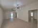 Spacious living room featuring tile flooring, ceiling fan, and sliding door to the backyard at 1019 34Th W Ave, Bradenton, FL 34205