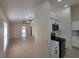 Open-concept living room and kitchen area featuring neutral tones and modern lighting at 1019 34Th W Ave, Bradenton, FL 34205