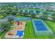 Overhead view of community amenities featuring a playground, tennis and basketball courts at 12851 24Th Street E Cir, Parrish, FL 34219