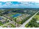 Wide aerial view of homes in a vibrant community featuring a picturesque lake at 12851 24Th Street E Cir, Parrish, FL 34219