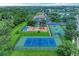 Aerial view of community amenities including a playground, tennis and basketball courts, and pool at 12851 24Th Street E Cir, Parrish, FL 34219