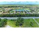 Beautiful aerial view of the lakeside community with lush landscaping and blue skies at 12851 24Th Street E Cir, Parrish, FL 34219