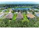 An aerial view of the community, showcasing well-maintained homes and a picturesque lake at 12851 24Th Street E Cir, Parrish, FL 34219