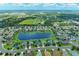 An aerial view shows the community with pond and landscaping at 12851 24Th Street E Cir, Parrish, FL 34219