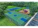 Aerial view of community basketball and tennis courts near a playground and parking area at 12851 24Th Street E Cir, Parrish, FL 34219