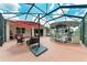 Expansive backyard featuring an outdoor kitchen, a tiki bar, an umbrella, and comfortable seating at 12851 24Th Street E Cir, Parrish, FL 34219