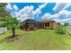 A meticulously landscaped backyard features a screened-in lanai and a well-manicured lawn at 12851 24Th Street E Cir, Parrish, FL 34219