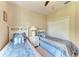 Bedroom featuring two twin beds with decorative pillows and a view of the closet at 12851 24Th Street E Cir, Parrish, FL 34219