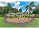 Welcome to River Plantation: a beautifully landscaped entrance sign surrounded by lush greenery at 12851 24Th Street E Cir, Parrish, FL 34219