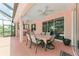 Inviting covered patio with dining table and ceiling fans overlooking the backyard and screened in lanai at 12851 24Th Street E Cir, Parrish, FL 34219