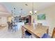 Kitchen with breakfast bar island adjacent to dining room with natural lighting at 12851 24Th Street E Cir, Parrish, FL 34219