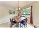 Dining room featuring wood table and chairs, chandelier, and window with view at 12851 24Th Street E Cir, Parrish, FL 34219