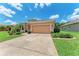 Charming single-Gathering home with a well-manicured lawn, a decorative driveway, and mature landscaping at 12851 24Th Street E Cir, Parrish, FL 34219