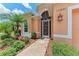 Close-up of the front entrance showcasing a decorative walkway and lush landscaping at 12851 24Th Street E Cir, Parrish, FL 34219