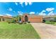 Charming home with a manicured lawn, decorative driveway, and mature landscaping at 12851 24Th Street E Cir, Parrish, FL 34219