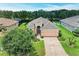 Well-maintained home features a lush lawn, landscaped beds, and a decorative driveway at 12851 24Th Street E Cir, Parrish, FL 34219