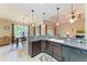 Well-lit kitchen with pendant lighting, granite countertops, and stainless steel dishwasher at 12851 24Th Street E Cir, Parrish, FL 34219