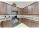 Spacious kitchen with dark wood cabinetry, granite countertops, and tile backsplash at 12851 24Th Street E Cir, Parrish, FL 34219