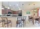 Modern kitchen featuring granite countertops, dark wood cabinets, and a breakfast bar at 12851 24Th Street E Cir, Parrish, FL 34219