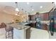 Open kitchen with granite countertops, stainless steel appliances, and breakfast bar seating at 12851 24Th Street E Cir, Parrish, FL 34219