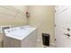 Efficient laundry room featuring modern washer and dryer with storage and access door at 12851 24Th Street E Cir, Parrish, FL 34219